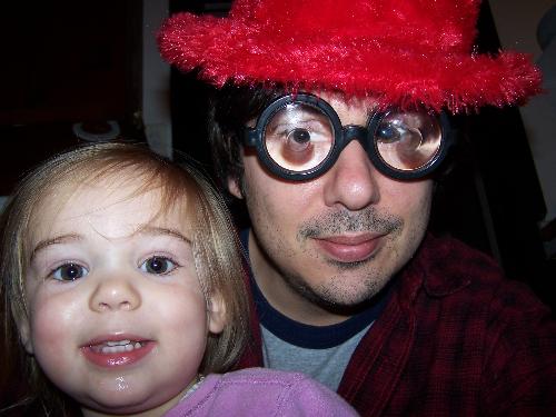 Zoe And I - Well I guess I thought the funny red hat would draw attention away from my coke bottle glasses, which are real. You should see how thick my contacts are. I can put two toghether and shoot marbles.