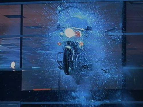 breaking bike - in tis pic the t1000 breaks the window of a multi storyed building n jumps from the bike in to a police helicopter...