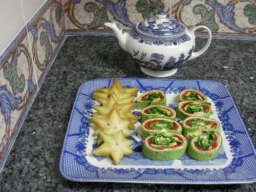 Turkey and Avocado Wrap - Sliced turkey bread, avocado and grilled and peeled sweet red bell pepper in spinach wrapper.  Platter garnished with  sliced starfruit.  Taken with a Nikon Coolpix 3200.