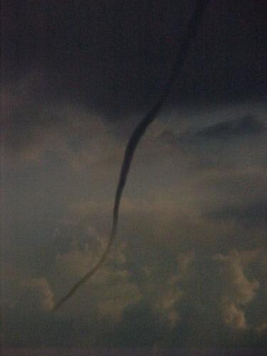 Funnel Cloud Out our back window - I took this photo from our bathroom window a couple of years ago.   The funnel stayed for almost 30 minutes and then went back into the sky. It was very weird it just sat in the same location and finally disappeared.
