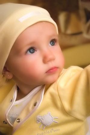 Happy Baby - This is a very cute baby. this image is special. just observe it. the baby is not laughing. usual only laughing babies are cute. so i think this photo is exceptional.