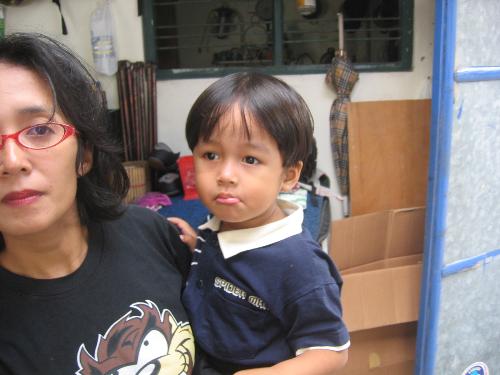 my son and my wife - This is my son and my wife. The picture was taken by the end of the year 2006 when he was only about three years old. It was taken in Malang, east Java, Indonesia. We are from Yogyakarta Indonesia and the picture was taken when we attended my younger broter's marriage. It was fun since yogyakarta is a very hot city and Malang is a very cool city. We stayed there for about 3 days. After we came back home, he got sick since he was not used to cool place.