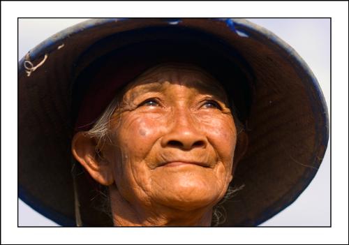 satisfied - A hard working old woman taking a break to enjoy her fields - she looked so satisfied.