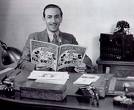 Walt Disney - Walt Disney at his desk working.