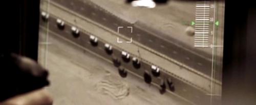 Syriana Screenshot 2 - The Americans are trying to launch a missile right on to the convoy of the Arab prince. To stop the Prince, they have sent an American which makes the convoy stop in the rough desert. And that's where the movie comes to the climax. This picture shows the convoy from the upper view of the aircraft from which the Americans launch the missile.