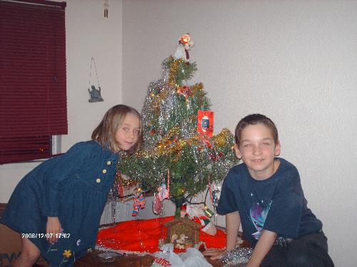 My kids - This is a picture of my babies... lol.. they had just finished decorating the christmas tree and wanted a pic taken.  Don't mind the red eyes.  I've yet to find a program to get rid of that.