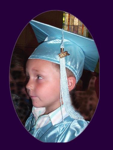 My son at his preschool graduation - My son at his preschool graduation held in the church auditorium.  He is wearing his cap and gown.