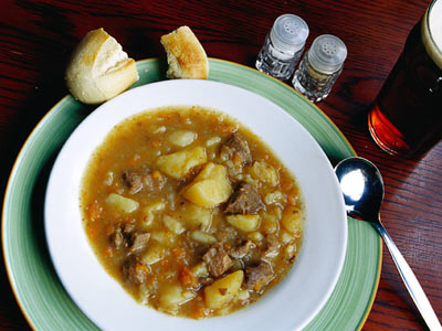 Bowl of heartening Irish Stew - Irish stew is a traditional Irish dish made from lamb or mutton as well as potatoes, onions, and parsley. It originated in Ireland but appears in cookbooks all over Europe. Irish stew is a filling, flavorful dish made with the most readily-available ingredients. The Irish raised primarily sheep and root crops for subsistence.