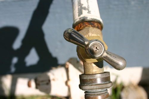 old rusty faucet - old rusty faucet with background slightly blurred