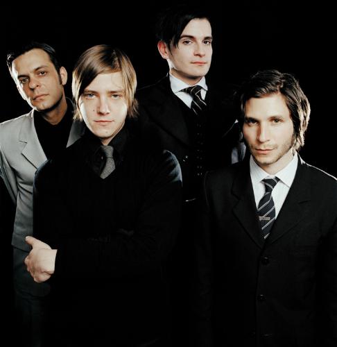 Interpol group pic - Interpol group picture in front of a black screen