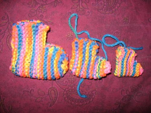 Rainbow booties. - Making a pattern for booties.
The tiny one was made on size 3 needles, the next one on size 6&#039;s from the same pattern. Then I tossed that pattern, wrote my own pattern, and made the third one.
