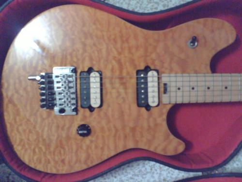 guitar - it's an evh wolfgang guitar made by peavey,designed by eddie van halen, basswood,hard maple neck,amber quilt top