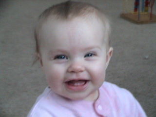 My smiling baby girl - She is 9 1/2 months and finally has some teeth and just loves to show them off.