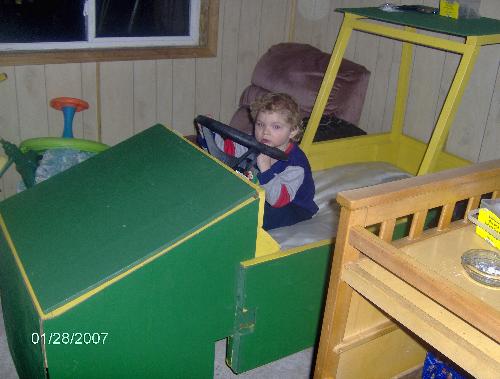 Another view of my grandson's bed - My grandson playing in his 'Poppy' made tractor bed.
