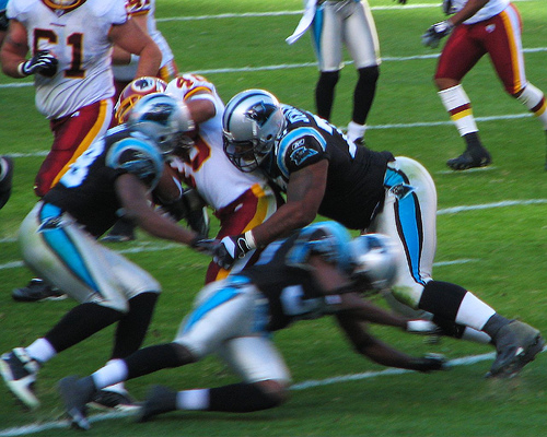 Redskins Football pt. 2 - Redskins running back getting tackled by the carolina panthers defense.