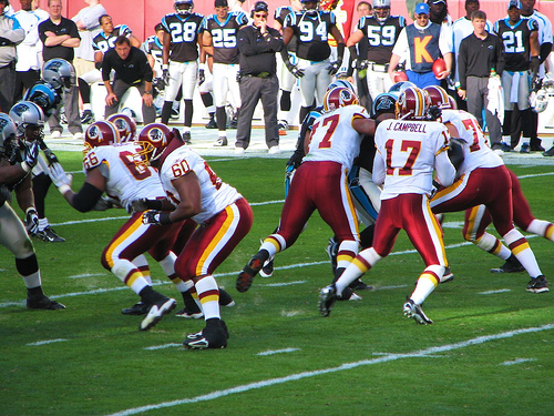 Redskins Football pt. 1 - Picture of the qb stepping back to make the throw.