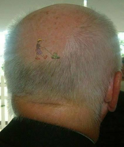 Tattoo - This is a pic of a guys bald head. he has a tattoo of a lawn mower that looks as if his head and remaining hair is being mowed...very clever and funny.
