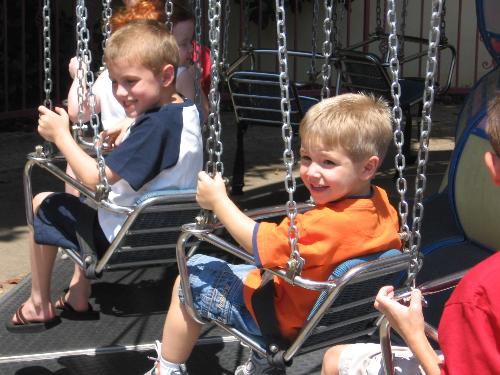 Bryson and Daniel on swings - This is Bryson and Daniel at Six Flags in the kids swings section.