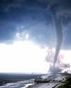 tornado - A rotating column of air ranging in width from a few yards to more than a mile and whirling at destructively high speeds, usually accompanied by a funnel-shaped downward extension of a cumulonimbus cloud.