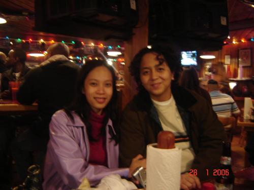 Me and Pam in Hooters, NC - We were the chosen few who went to the United States to train for one of our accounts. This picture was taken in Hooters in Greensboro, NC during our free time when my friend Pam (the one with the long hair) lost a bet but gained back her lost wallet. After seeing and hearing about Hooters in movies, this was definitely a memorable experience.
