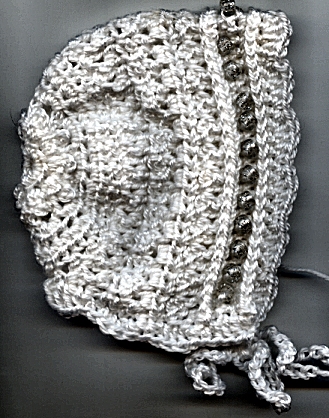 Handmade Crocheted Baby Bonnet that I made - I tried putting beads on this bonnet--just pony beads and it looks ok, but if the baby sleeps on his/her side while wearing the bonnet, it might be uncomfortable.