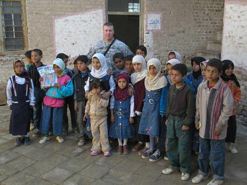 one of my friends in Iraq with the school kids - This is my friend who  is over in Iraq with some of the Iraqi kids that the american soliders have become friends with because they built them a new school