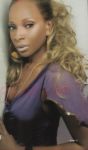 Mary J. - Mary J Blige wearinag a purple top in a nice pose.