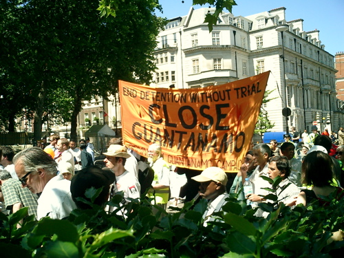 Guantanamo Bay Protest in Britain - 15 July 2006 - The Close Guantanamo Bay protest was attended by, I guess, 500 people.  The march started at Marble Arch in the blazing sun at 12.30 and proceeded to the front of the American Embassy, which was very close by.  The police presence was staggering for such a small crowd. There were police at the beginning, during at at the end of the march. We also noticed vans of police (sitting inside roasting in the sun) on side streets at Grosvenor Square.  There was a short introduction carried over a quite good p.a. Then a series of people gave impassioned speeches on the atrocities committed by the American administration and the complicit help given by Britain.  (www.indymedia.org.uk/en/2006/07/345171.html)