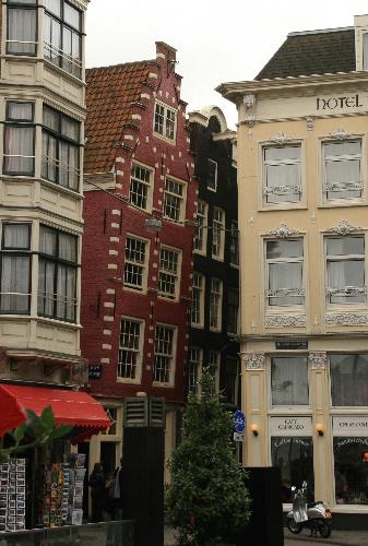 My favorite Amsterdam Building - I am currently living in Amsterdam, NL, and this red leaning building stole my heart.  I love how it seems to be reaching for the pretty white one accross the street.  Amsterdam is full of leaning buildings, but not many that are this dramatic.