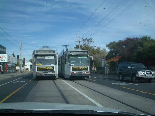 Passing tramcars in Melbourne Victoria Australia - Two tramcars pass each other head on, on one of Melbourne, Victoria, Australia's suburban streets. Jan, 2007.