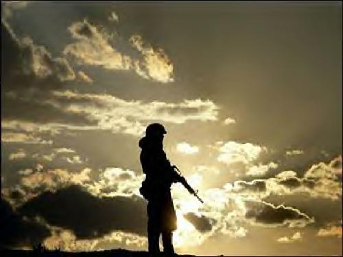 soldier - soldier alone standing watch as the sun goes down