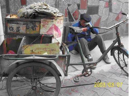 Old Man Crying - The old man sells roast yam for a living. Because he doesn't have a license, his tools were confiscated and his tricycle was smashed, its chain cut.  All the old man can do is to sit there and cry. Tomorrow.