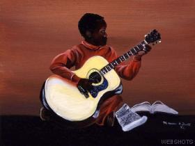 Playing guitar - A young verry talented boy from west-indies playing accoustic guitar in a jam session. Check out the picture here.