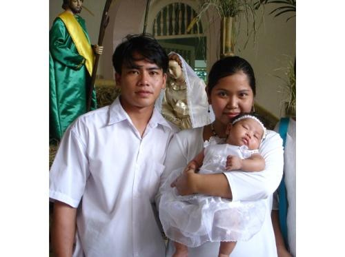 family picture - This is a picture of my husband , me and my daughter at her baptismal day on January 2, 2005 at our Parish church.  I am so happy that we are blessed with a healthy baby girl as you will see in her. You can see how happy i was.