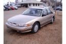 car - 1997, gold oldsmobile, cutlass supreme.  4 door, v6 motor