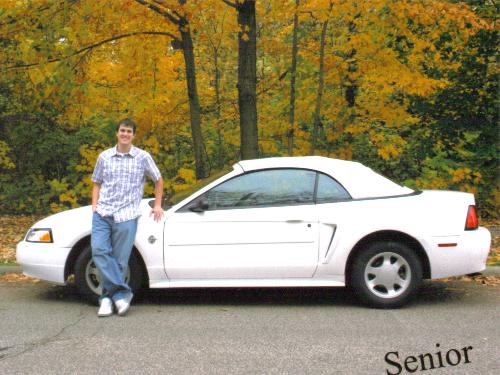 1999 Mustang convertible - this is my 1999 Mustang Convertible. i love cars with a passion. it has more stuff on it cause this is an old picture. it has a cool air intake, neons, 18' powder coated rims with low pro tires, motorized dvd/tv player with system, and a new black top.