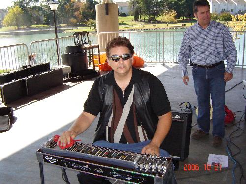 PLAYING PEDALSTEEL  w/h TARA ALISON&theroad less t -     thisis a photoshot of me playing pedalsteelguitar live'on stage at the pineville festival with tara alison&the road less traveled band we played outside at the recreational palatiom park in pineville nc at around 2;00 in the afternoon saturday 2006 . the turn out was great there were around maybe 1500-2000 people there that day it was a real exciting' day for us .