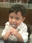 My bundle of joy - Qiffy, at 3yrs of age.  At Swensen&#039;s ice cream parlour.  As you can see, he enjoys his ice cream so much that he&#039;s cleaning at bit of ice cream on his spoon.  
