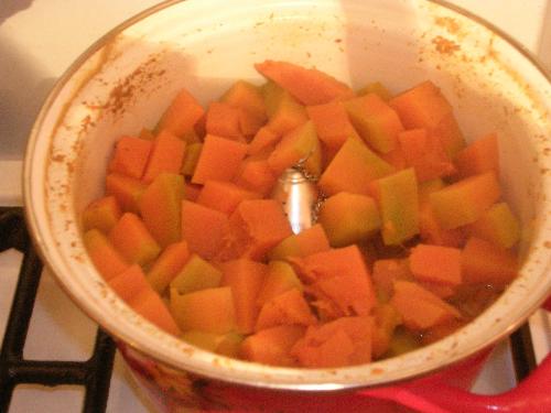 Pumpkin Chunks Becoming Pie - I made this pie for a Thanksgiving dinner I hosted in Eastern Ukraine in 2005. I bought part of a pumpkin in the market. The usual spices were available whole, not ground, and I didn't have access to a aspice grinder. I decided to put the whole spices in a tea ball (see in center of pot) and cook the flavor into the pumpkin while it was cooking down to a paste. I removed the ball and strained its contents through cheesecloth afterwards, then beat the mashed pumpkin with the cream, eggs and sugar. I made the crust with a combintion of lard and butter along with the usual flour, etc., and flavored it with grated orange zest.   Pumkin pie was an unknown and exotic dessert to my Ukrainian guests, and they loved it!