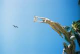 sculpture on beach - sculpture with bird in background