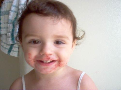 Emma strawberry face - Emma likes freeze dried stawberries!! I was on the phone and not paying attention to her and this is what I found when I got back!! So cute, but boy was it hard to clean!!!