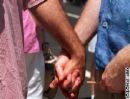 holding hands - a photo of two men holding hands