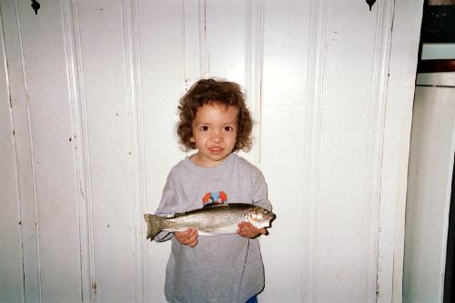 First Fish - This is my son posing with the first fish he ever caught. He was 3 years old at the time. The fish was 13 inches. We just went to this little river down by the rest area. It was late April and still a little too cold to expect to catch much of anything, but Andrew wanted to go. So Grandpa and I decided to take him just for the bonding experience. Imagine our surprise when in less than 20 minutes Andrew had caught this one. We went on to catch two more.