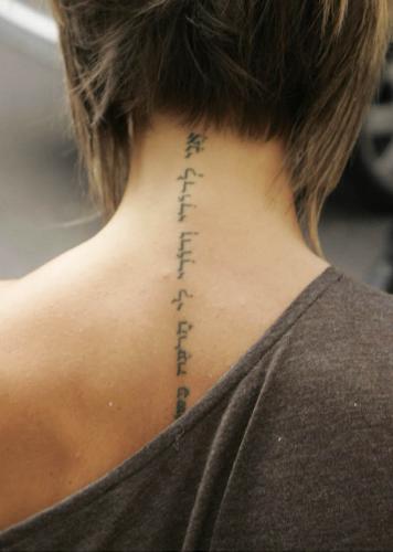 Victoria Beckham tattoo - This is a photo of Victoria Beckham's tattoo. It is down the back of her neck to her back, very thing, and in I believe Hebrew, but please correct me if I'm wrong.