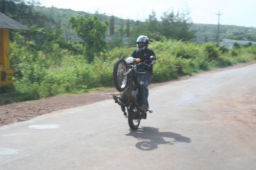 My Wheelie - That's me doing a stand-up wheelie on my Yamaha RX 135 2 stroke motorcycle. It was a 2nd gear wheelie down the road.