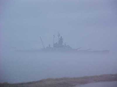 Coming out of the fog. - A naval ship coming in through the fog