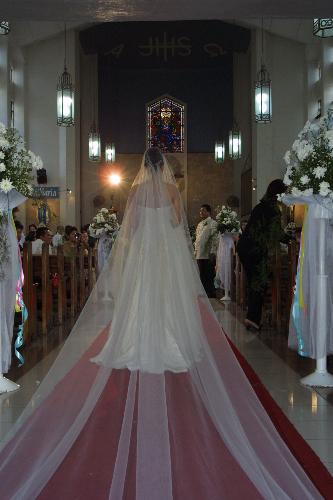 walking down the aisle - bride walking down the aisle to her groom