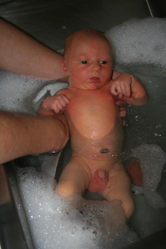 Forced to bathe - a baby is being bathed