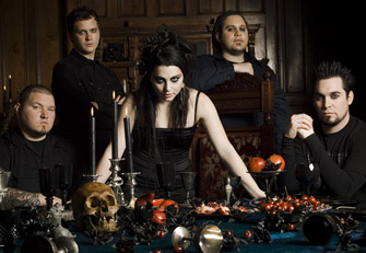 Darker Amy Lee - This photo was sent to me by a friend. It shows Amy Lee darker than usual with her bandmates in the background at a beautifully gothic dinner table.