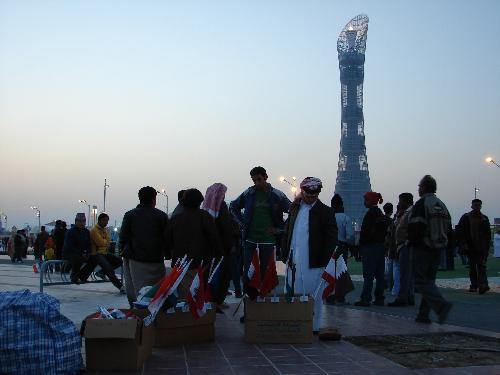 Colors Of The 15th Asian Games - Doha Qatar - I took this picture of a Qatari man selling flags of the countries involved in the closing ceremony of the 15th Asian Games. This was taken just outside of the Khalifa Stadium where the opening and closing ceremonies took place.
